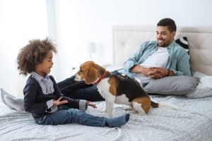 Cute african american girl playing with her dog.